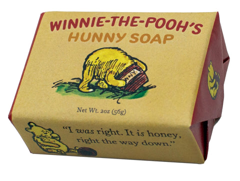 A small bar of honey scented soap that depicts an illustration of Winniethe-Pooh sticking his head into a jar of honey.