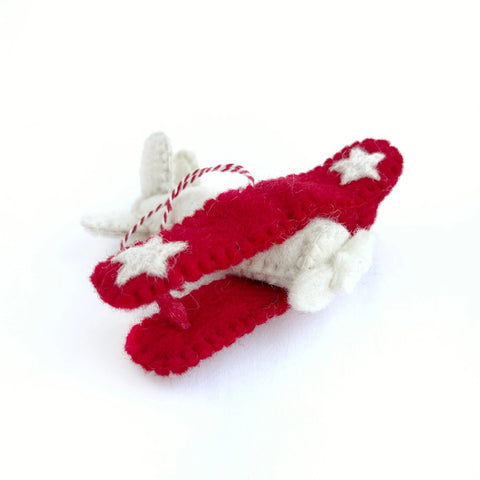 Felt wool red and white biplane ornament with white stars on it's wings and a red and white striped hang 