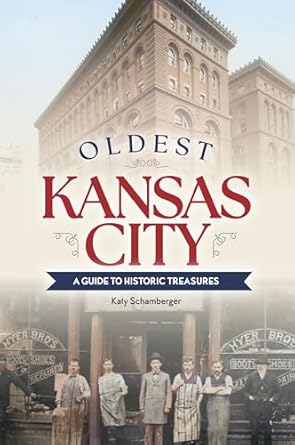The cover is a vintage colored photograph of seven men dressed in vintage style clothing standing in front of an old building. 