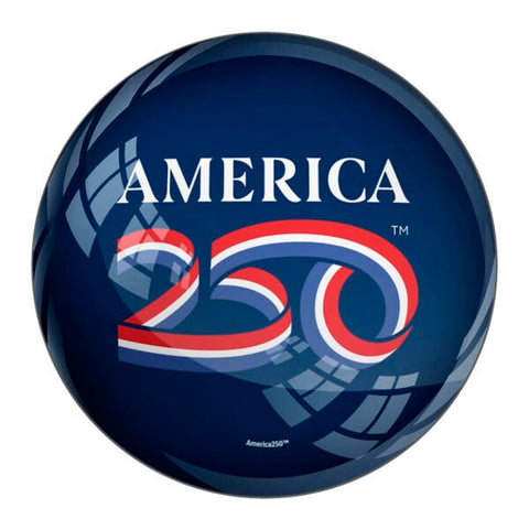 A blue round paperweight that has the text "America 250" on it. "250" is illustrated to look like a ribbon with the American flag colors.