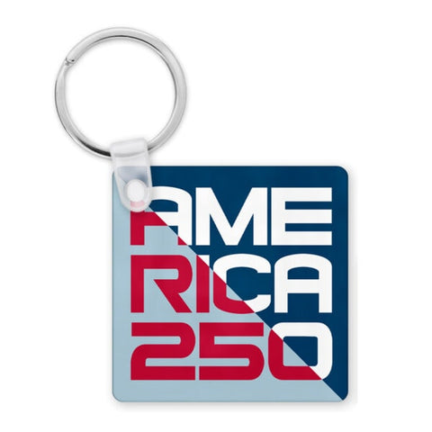 A blue, red, and white keychain that says America 250. The color scheme is split in half, with one side being blue and white and the other side being light blue and red.