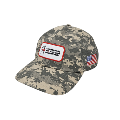 Camouflage cap with a patch for the National WWI Museum and Memorial and American flag on a white background