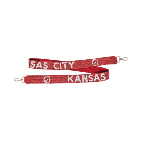 Red beaded strap with texts that reads "Kansas City" on it.
