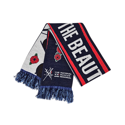 A dark blue, red, and white soccer scarf with poppy flowers and the logo for the National WWI Museum and Memorial. Across the scarf is the exhibition title The Beautiful Game.