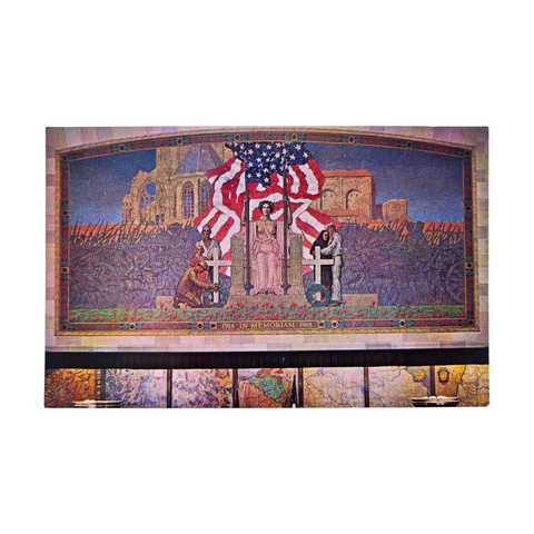 A postcard with a photograph of a mural in  the WWI Museum and Memorial titled "In Memoriam"". It depicts a woman sitting in a chair with the American Flag waiving behind her. There are crowds of tired solders in the background, and a pair of people at each side of her. In the front are poppies.