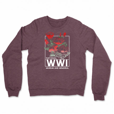 Image of a wine colored fleece with a bright graphic design of a poppy flower. The colors are red, green, and white. The poppy flowers are framed by a white rectangle, with the words National WWI Museum and Memorial at the bottom.