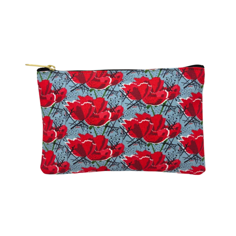 A small rectangular pouch with a bold red poppy pattern on a bluish gray background, featuring a zipper closure. 