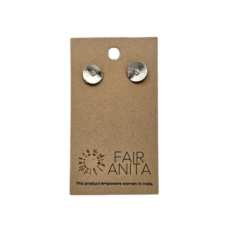 Silver stud earrings in the shape of a poppy flower. They are packaged on a brown slip of cardboard which has the brand name, "Fair Anita" on it.
