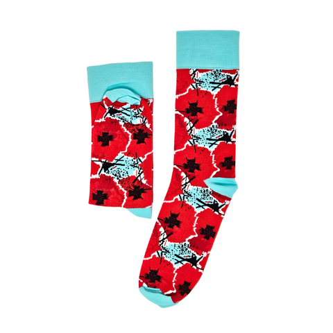 This image contains a pair of socks with digitally manipulated poppies that are repeated and stacked on one another with the National WWI Museum and Memorial Intersections logo interlaced between. The socks have a color theme of red poppies, with light blue accents. It also has a light blue heel, toe, and band. The socks are on a white background, with the left one being folded in half and the right one open.