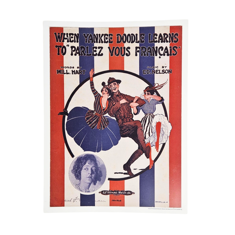 A replica of a WWI era poster. It depicts a man and two women dancing and has a blue and red striped background. At the top of the poster is text that reads "When Yankee Doodle learns to 'parles vous Francais'".