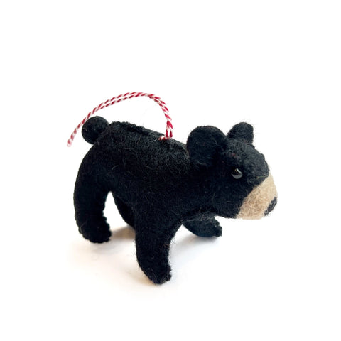 Black felt wool bear ornament with a red and white striped hand thread.