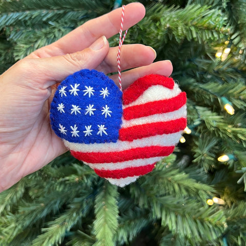 American flag patterned felt wool heart-shaped ornament with a red and white striped hang thread.