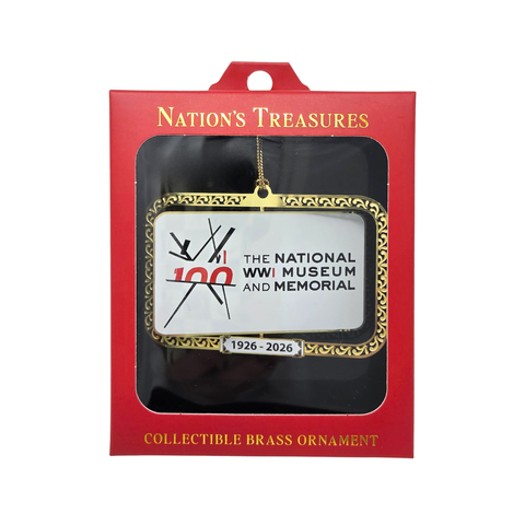 Brass ornament in a red box. The ornament has the Centennial Logo for the National WWI Museum and Memorial.