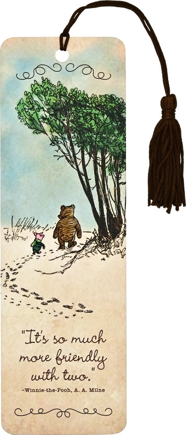 A bookmark that depicts and illustration of Pooh Bear and Piglet walking in the snow together. It has a black tassel and a quote about friendship.